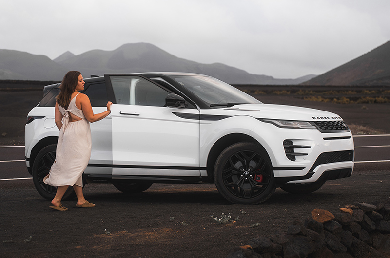 A woman next to an electric car in the Canary Islands